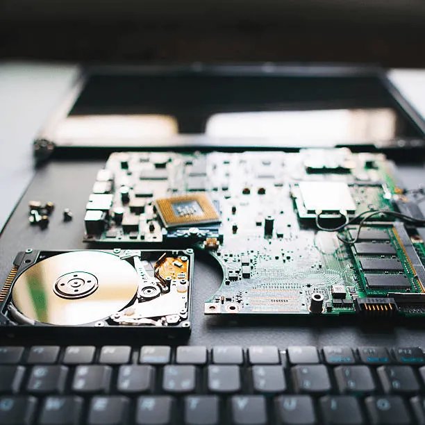 Open laptop showing its circuit board and hard drive