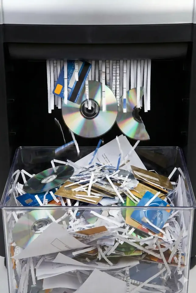 Illustration of optical discs being fed into a shredder